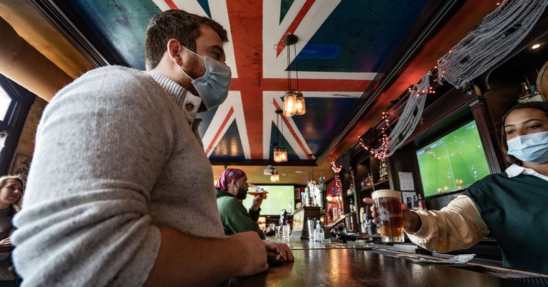 Bartender serving a guest with beer