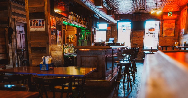 Interior, bar area, wooden top bar with stools, drink shelves, table for four