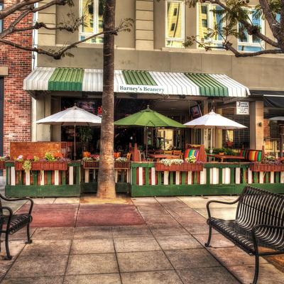 Outdoor seating area with green and white awning