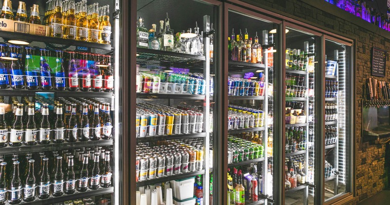 Beer fridges full of bottles and cans