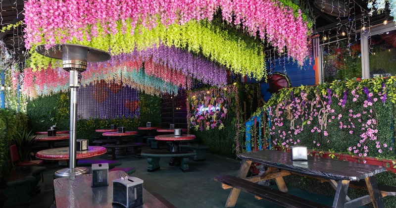 Covered seating area with picnic tables and circular tables with benches