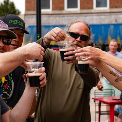 Group of people cheering with shot glasses.