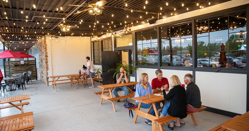 Outdoor seating area, a conjoined tables and benches