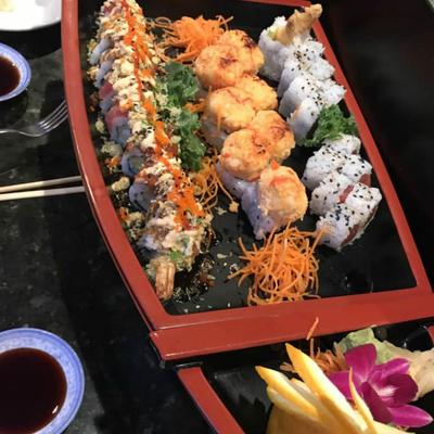 Large platter of assorted sushi with different types of sushi rolls.