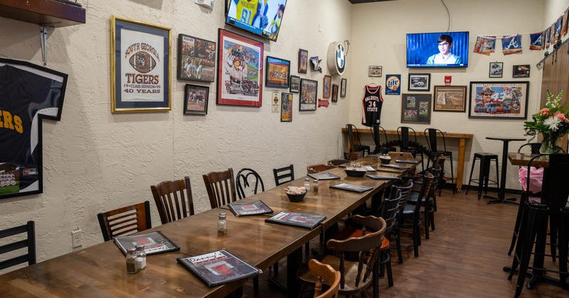 Seating area, long table with chairs, decorated walls