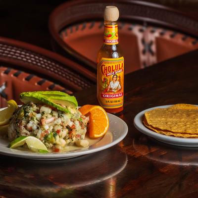 Ceviche, served with a drink.