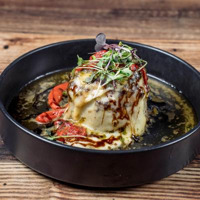 Stuffed Onion topped with melted mozzarella, microgreens and balsamic glaze.