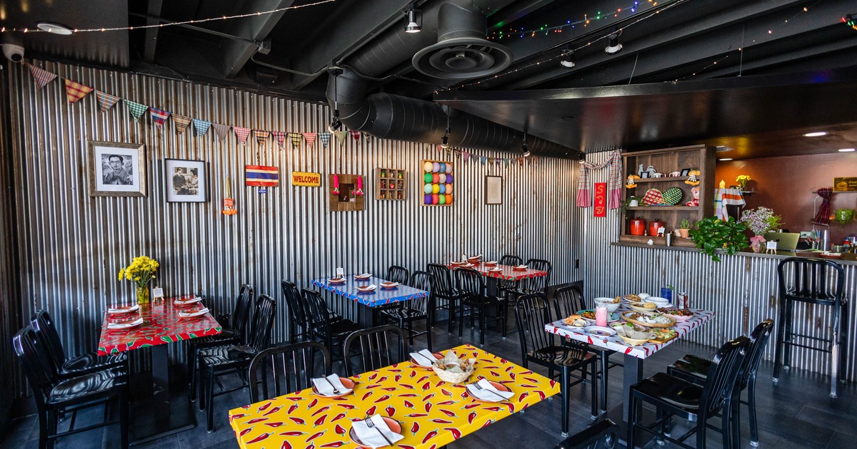 A lively restaurant interior featuring colorful tables, decorative wall elements
