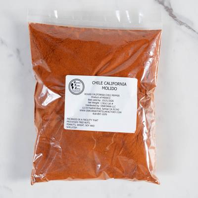 Ground red chile powder in a plastic bag with a label.