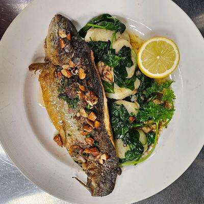 Whole Branzino with potatoes and spinach.