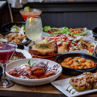 Table filled with assorted dishes and colorful drinks.