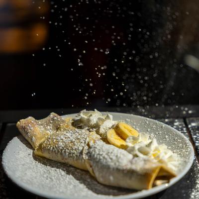 Crepe with bananas and whipped cream.