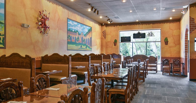 Wide view of the restaurant dining area, tables and booths