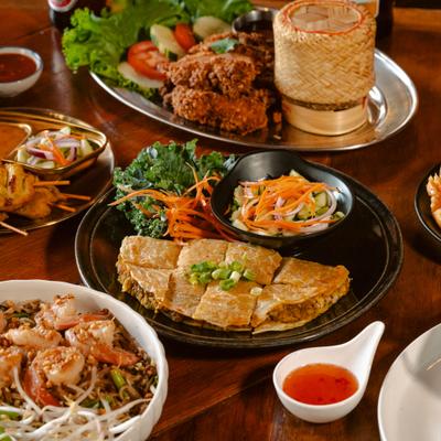 An assortment of delicious Thai street food dishes arranged on a table.