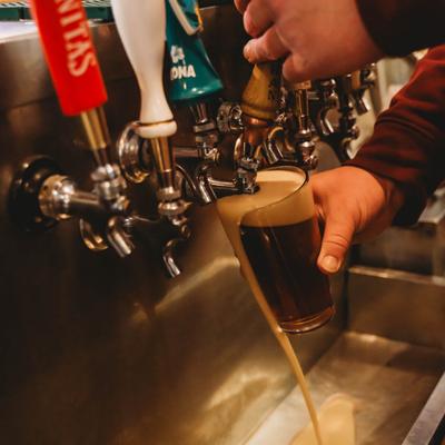 Pouring a glass of beer.