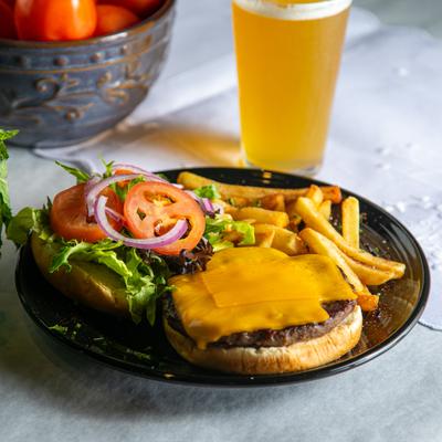 Attiki burger served with fries, accompanied with a glass of beer.