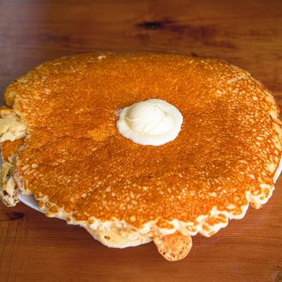 Large pancake topped with melting butter.