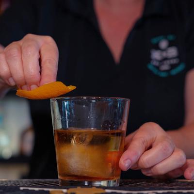 Bartender making an Old Fashioned cocktail.