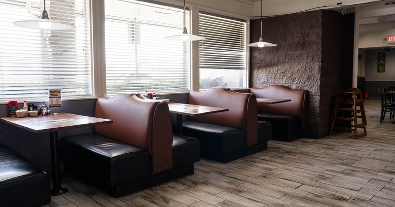 Interior, dining area, leather sheathed booths with tables, large windows with blinds