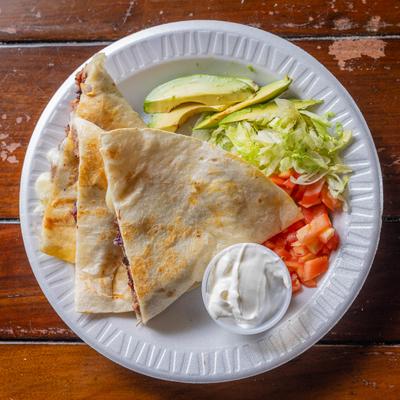 Quesadilla with sour cream and salad.