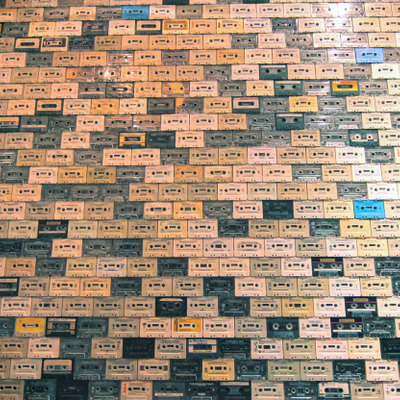 Wall covered with cassette tapes.