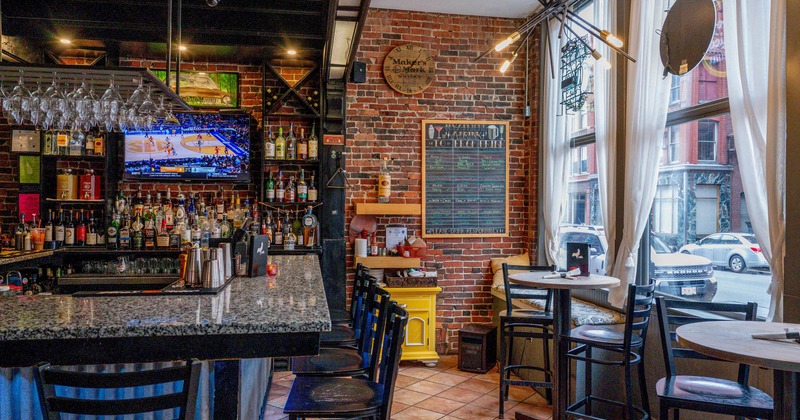 Interior, bar and high seating area, large shop window, exposed brick walls, tile flooring