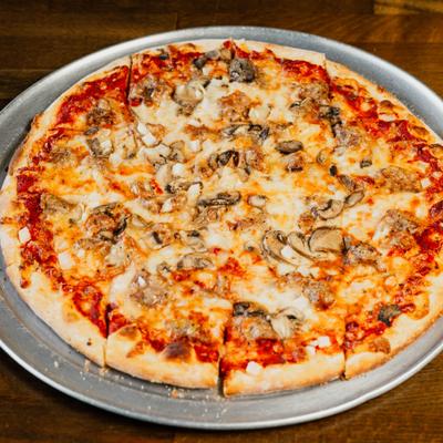 Sausage and mushroom pizza on a metal tray.