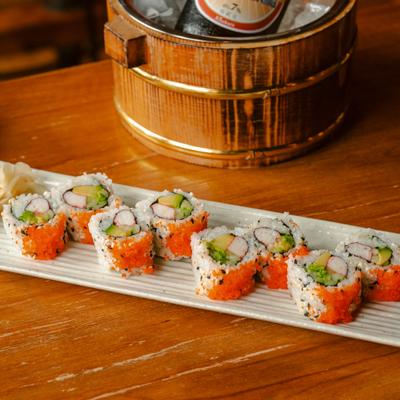 California maki roll served on a rectangular white plate.