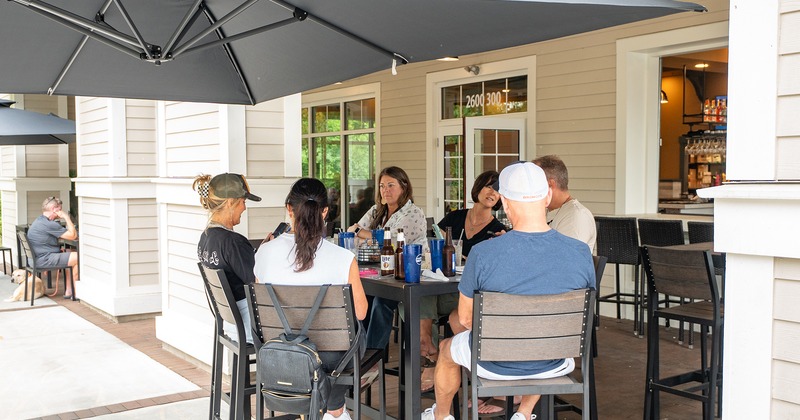 Outdoor seating area, guests chatting and enjoying their drinks