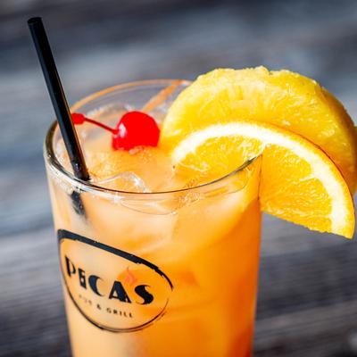 Orange Pica's Punch, garnished with cherry, orange and pineapple.