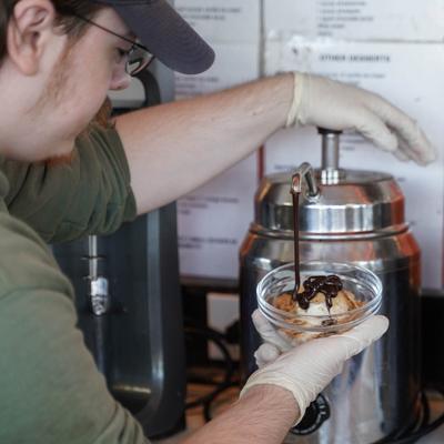 adding hot fudge to a ringo sundae.