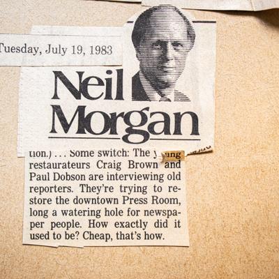 A 1983 newspaper clipping featuring a headshot of Neil Morgan with his article below