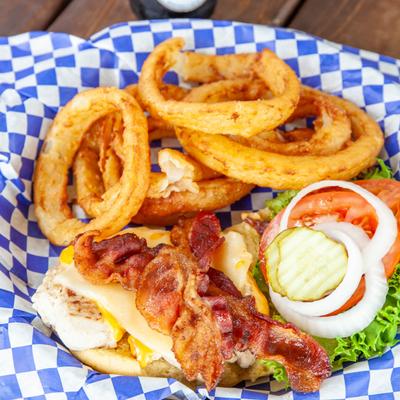 Grilled chicken sandwich, with bacon, cheese, lettuce, tomato, onion, and onion rings.