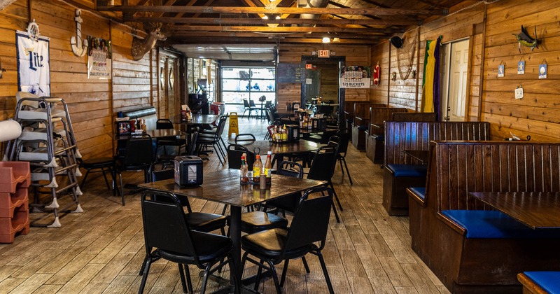 Interior, dining area, tables for four, wooden seating booths with tables, wood coated walls