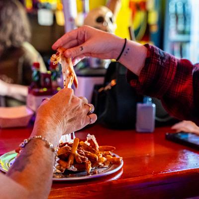 Hands grabbing food.