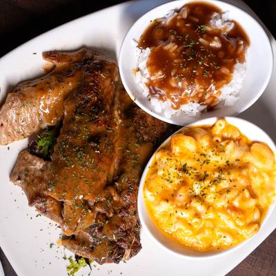 Turkey wings smothered with gravy served with rice and creamy baked mac and cheese.