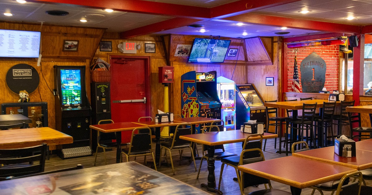 Interior with tables, chairsa and multiple arcade games