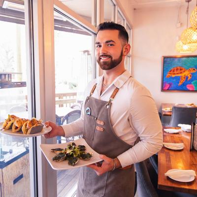 Smiling waiter serving.
