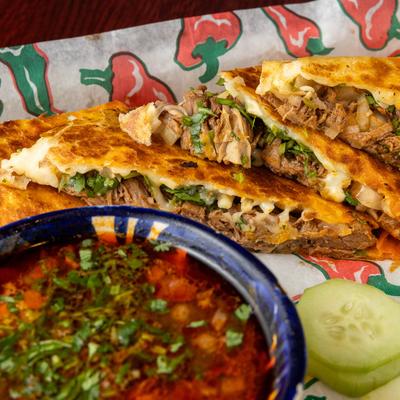 Birria tacos, served with consomme.