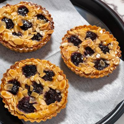 Sweet cherry and toasted almond tarts, top view.