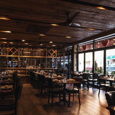Dining room with large windows and wine displays.