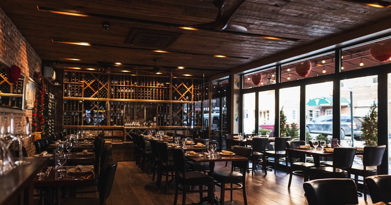 Interior with wooden elements, wine racks, and large windows