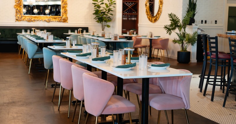 Interior, dining area, tables for eight with elegant chairs, concrete flooring