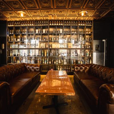 Lounge leather sofa seating in the bar area, a rack with liquor