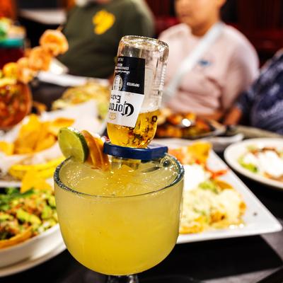 A drink and served meals in the background.