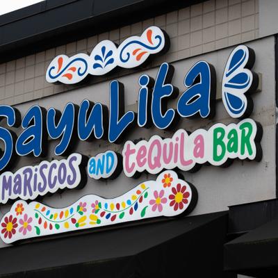 Colorful restaurant sign above the front entrance.