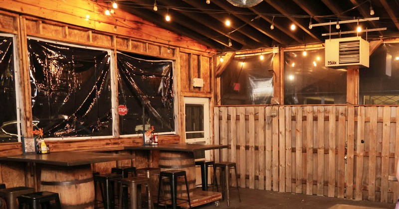 Interior, wooden barrel tables and high chairs