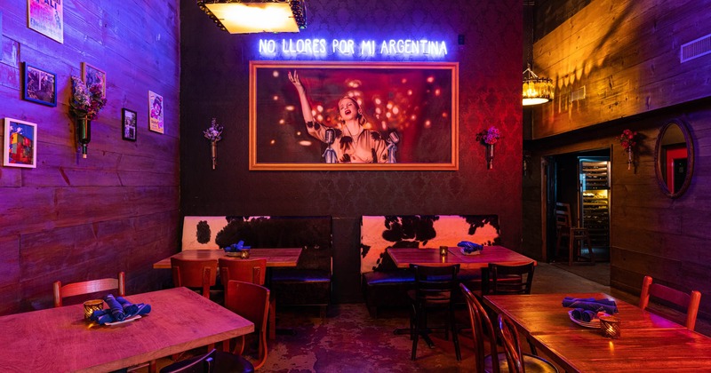 Dining area with huge paining and neon sign on wall