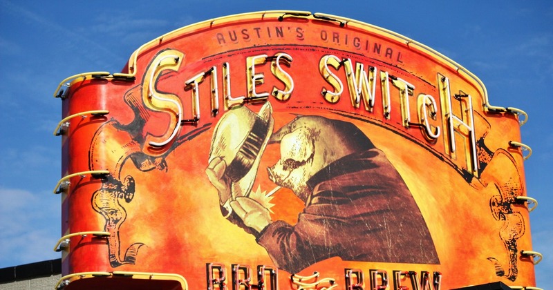 Exterior, restaurant signage, neon lights and painted pig in a hat