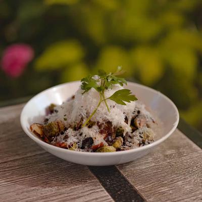 Charred Brussel Sprouts with bacon, balsamic glaze and shaved parmesan cheese.